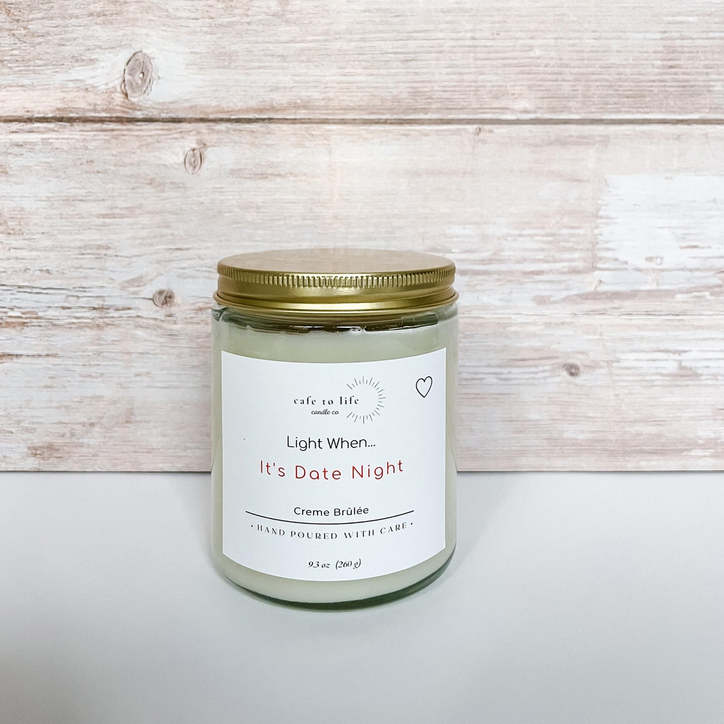 Glass candle with gold top. Label on candle says "Light When... It's Date Night"