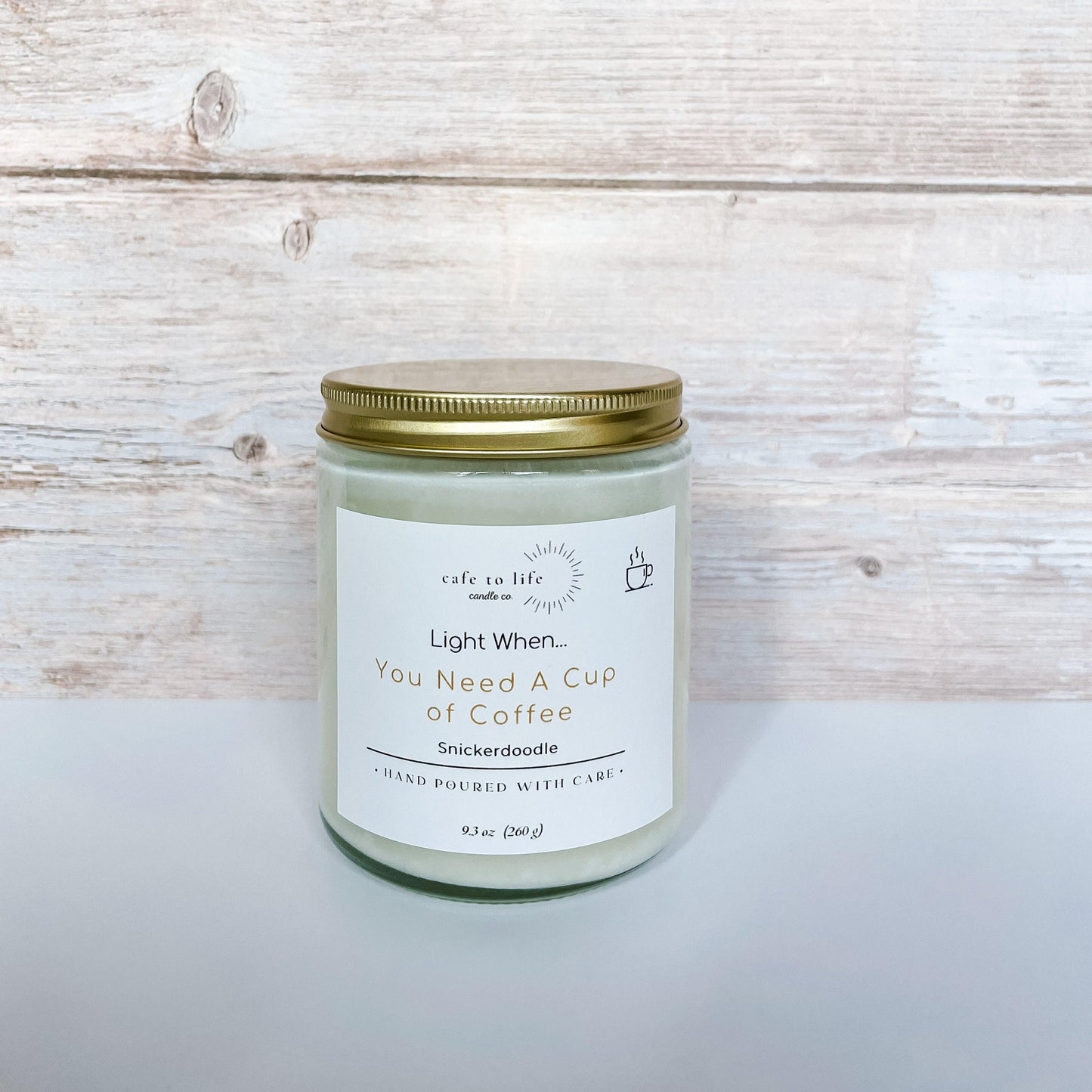 Candle with gold top. Label says "Light When... You Need a Cup of Coffee"