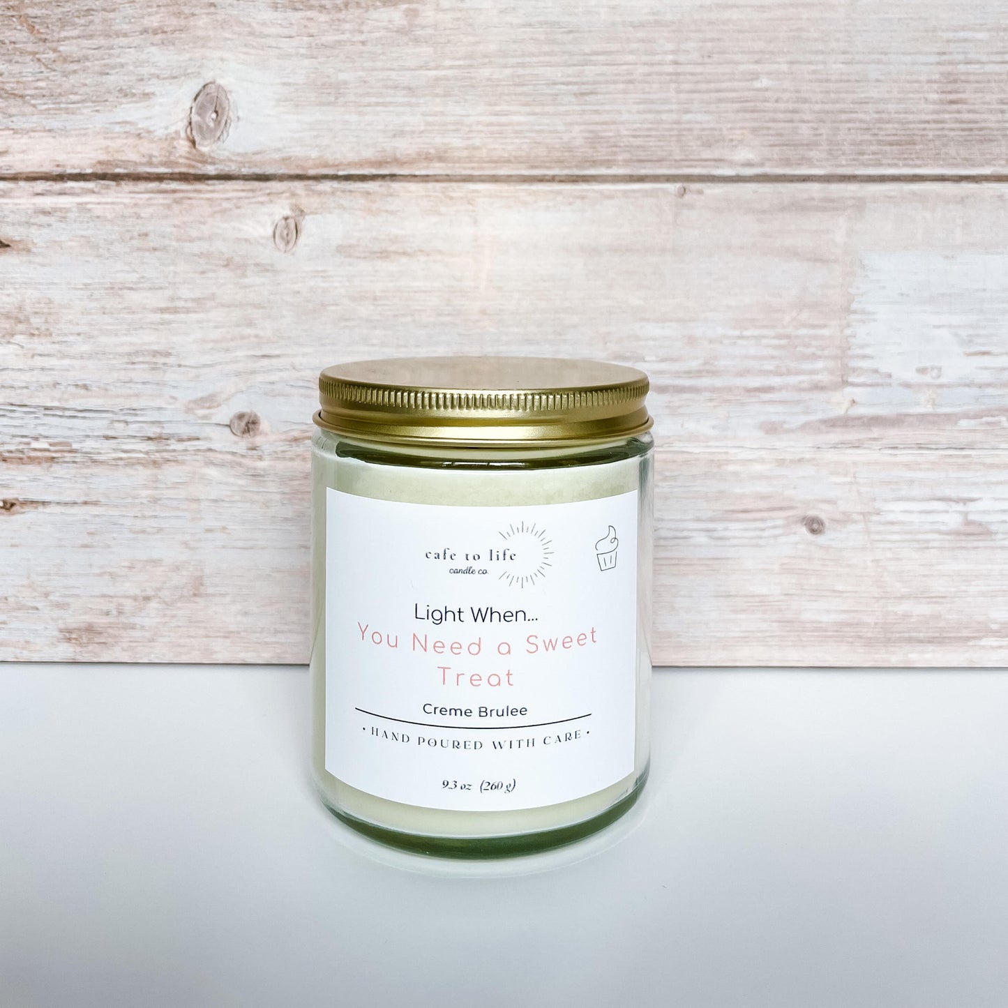 Candle with gold top screwed on. Label says "Light When... You Need a Sweet Treat"